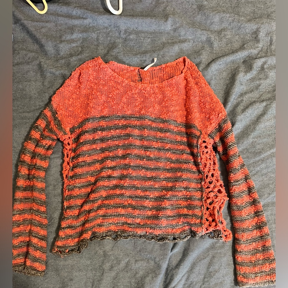 Free people sweater with waffle knit openings on sides.